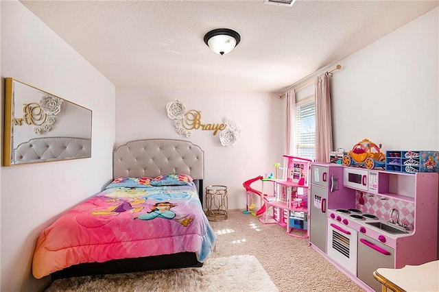 carpeted bedroom with a textured ceiling