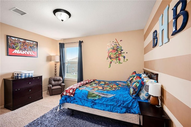 carpeted bedroom with baseboards, visible vents, and a textured ceiling