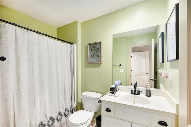 bathroom with toilet, curtained shower, and vanity