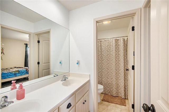 full bathroom featuring double vanity, toilet, ensuite bath, and a sink