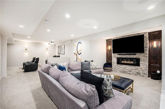 living room featuring a fireplace, recessed lighting, light colored carpet, and baseboards