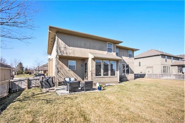 rear view of house with a lawn, a fenced backyard, and a patio area