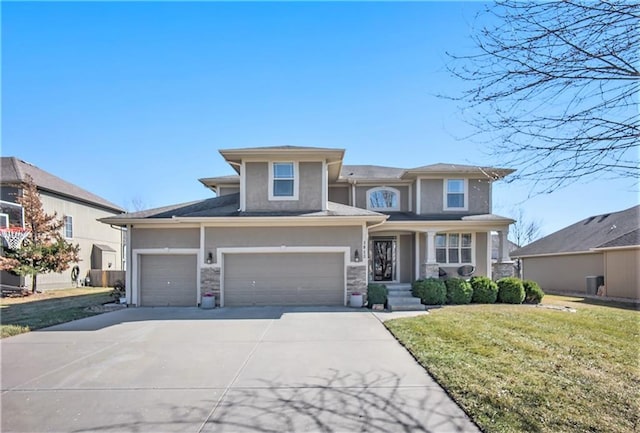 prairie-style home with stucco siding, driveway, and a front yard