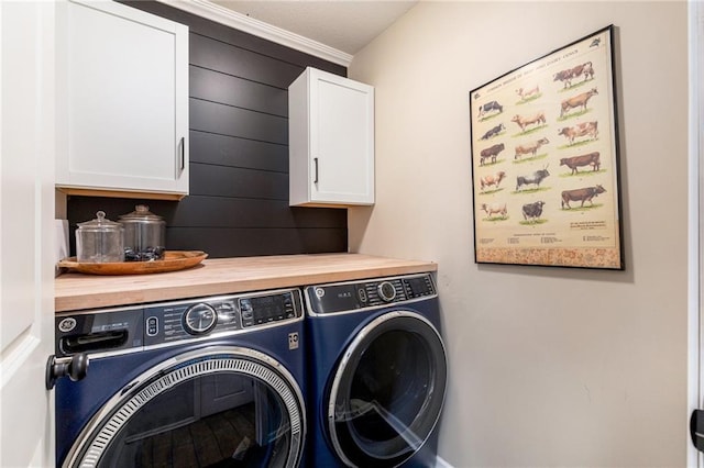 laundry area featuring washing machine and clothes dryer and cabinet space