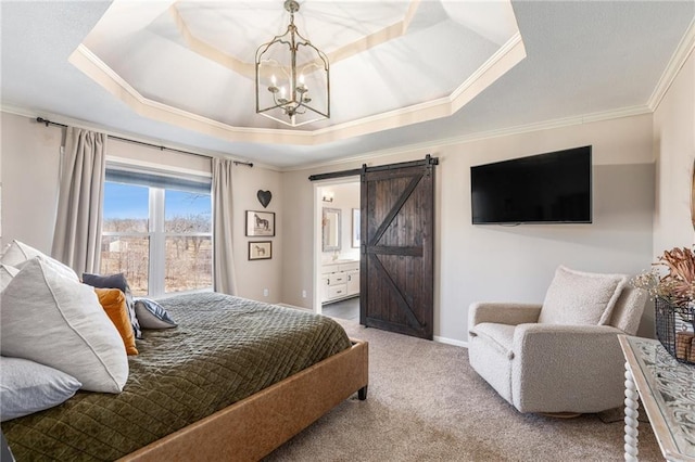 carpeted bedroom featuring baseboards, a tray ceiling, ornamental molding, ensuite bathroom, and a barn door