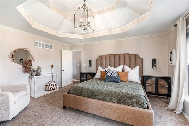 bedroom featuring an inviting chandelier, a tray ceiling, carpet flooring, and visible vents