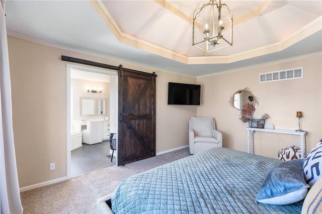 bedroom with visible vents, a notable chandelier, a tray ceiling, a barn door, and carpet floors