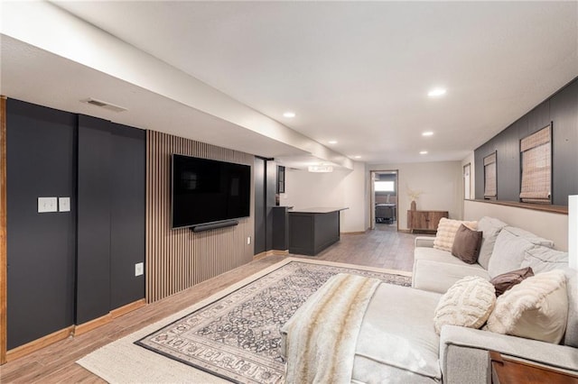 living area featuring recessed lighting, visible vents, and light wood-type flooring