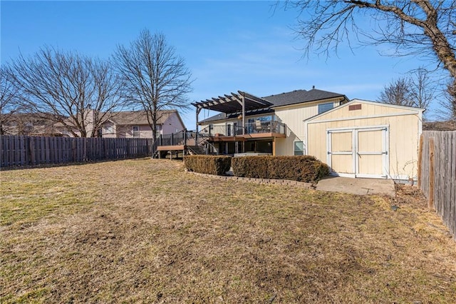 view of yard with a storage shed, a fenced backyard, a pergola, and an outbuilding