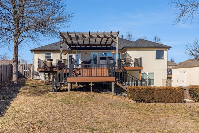 back of house with stairs, fence, a lawn, and a wooden deck