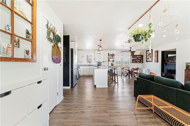 living room with ceiling fan and wood finished floors