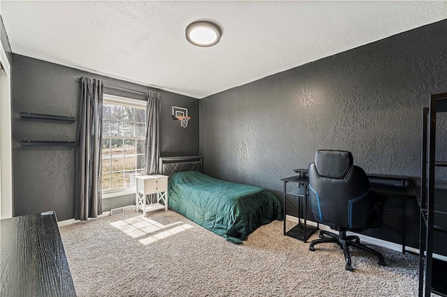 carpeted bedroom with baseboards, a textured ceiling, and a textured wall