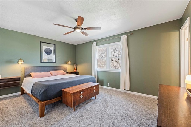 carpeted bedroom with baseboards, a textured ceiling, and ceiling fan