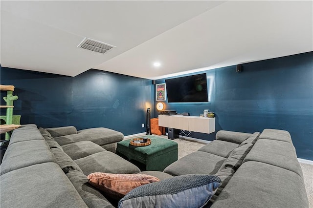 cinema room with visible vents, baseboards, and carpet flooring