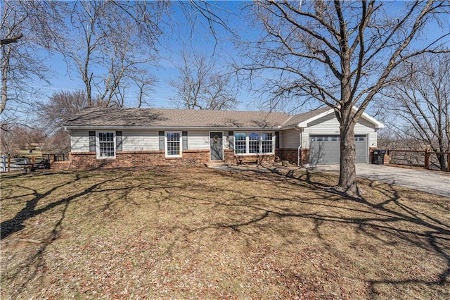 ranch-style house with a front lawn, brick siding, an attached garage, and driveway