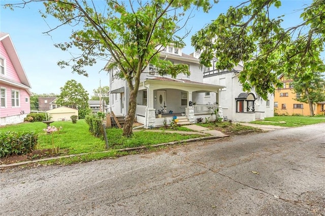 traditional style home featuring a porch and a front yard