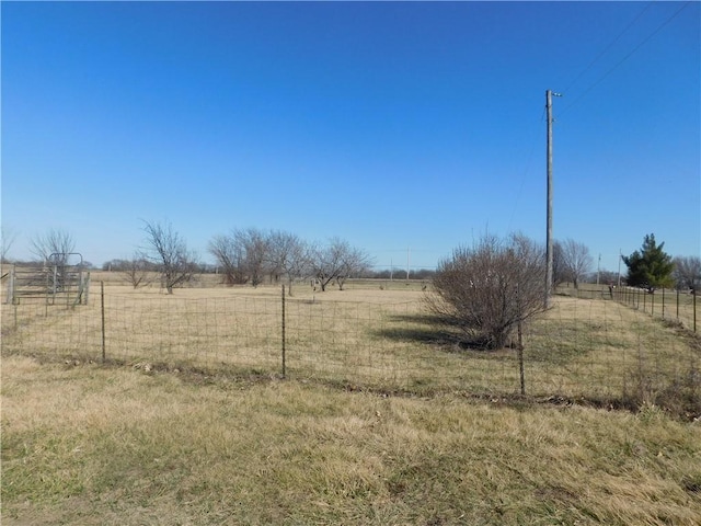 view of yard featuring a rural view and fence