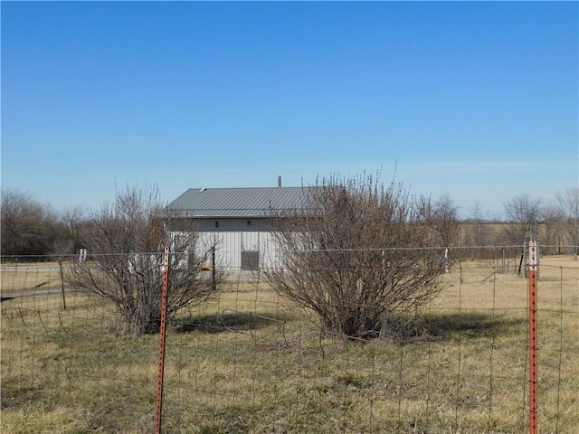 view of yard featuring a rural view and fence