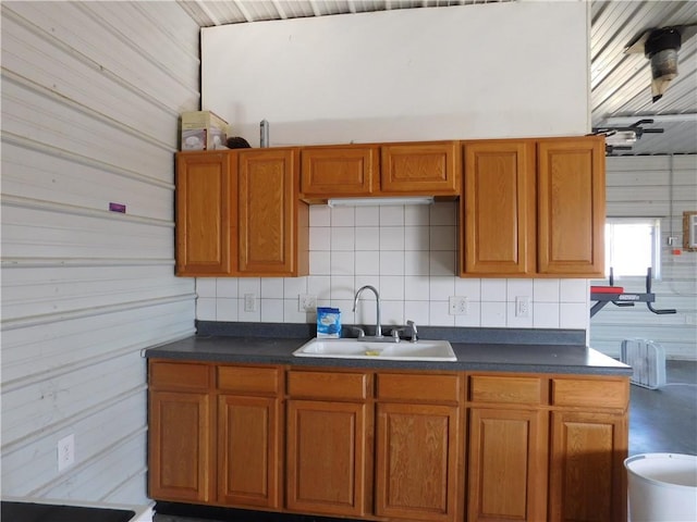 kitchen with dark countertops, brown cabinets, and a sink