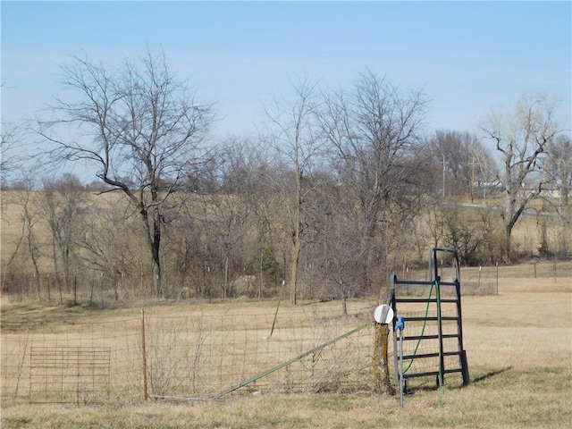 view of yard featuring a rural view and fence