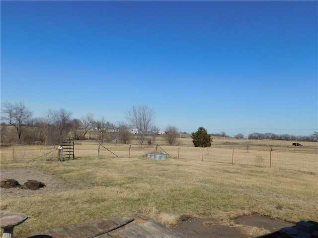 view of yard featuring a rural view and fence