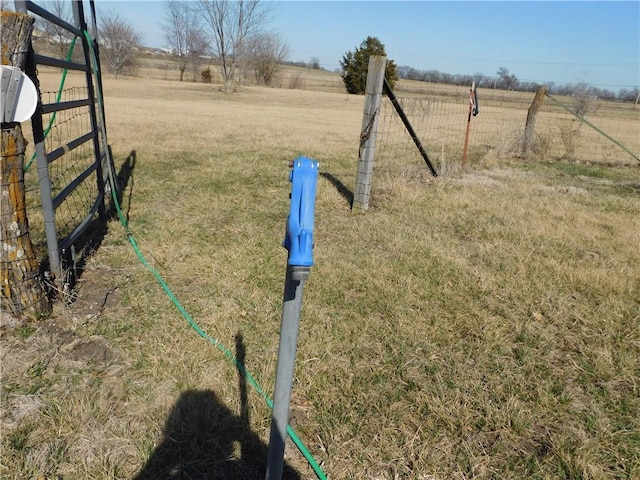 view of yard featuring a rural view and fence