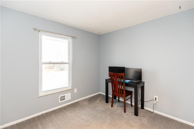 home office featuring carpet flooring, baseboards, visible vents, and a textured ceiling