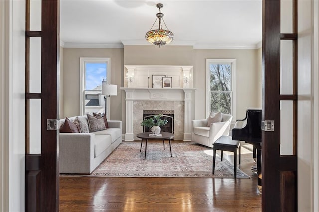 living room featuring a fireplace, wood finished floors, and crown molding