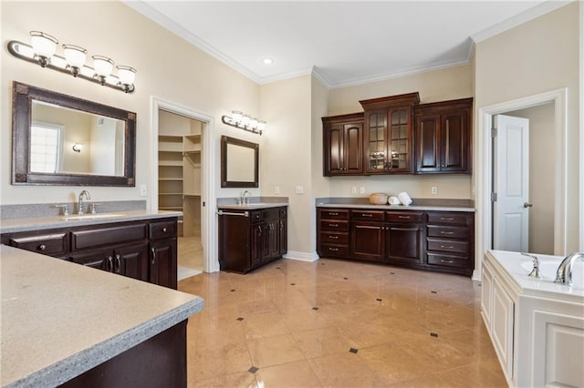 full bath with a sink, two vanities, baseboards, and ornamental molding