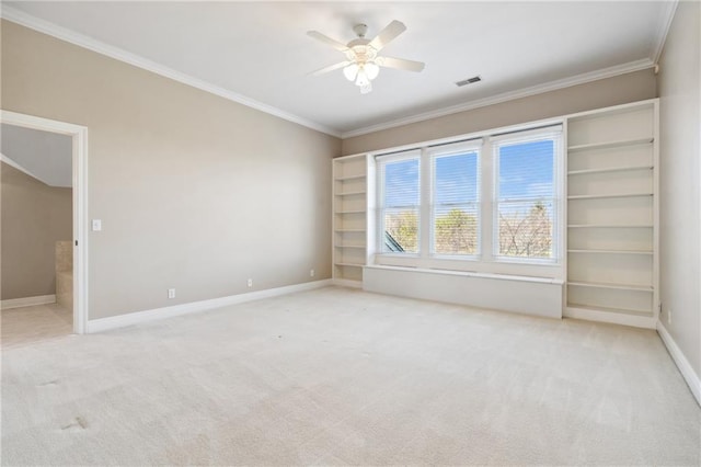 spare room with light carpet, visible vents, baseboards, and ornamental molding