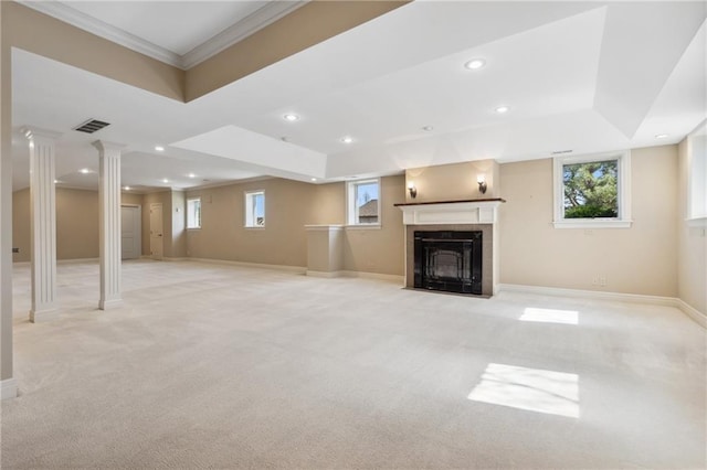 unfurnished living room featuring baseboards, light carpet, a raised ceiling, and a tile fireplace