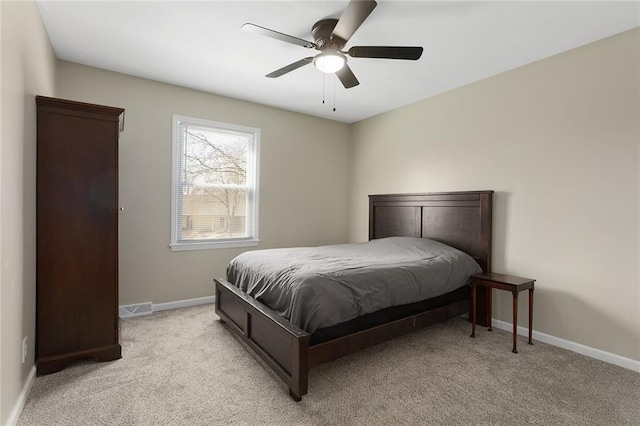 bedroom featuring light carpet, visible vents, a ceiling fan, and baseboards