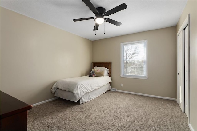 bedroom featuring a closet, carpet flooring, ceiling fan, and baseboards