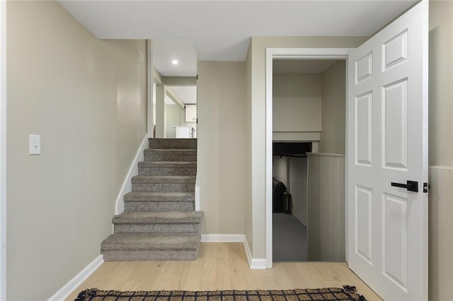 stairway with baseboards and wood finished floors