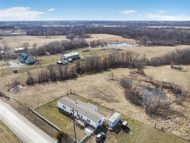 birds eye view of property featuring a rural view and a water view