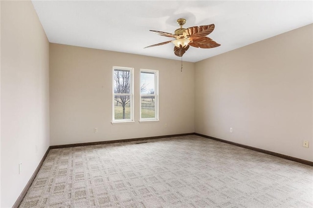 carpeted empty room with baseboards and ceiling fan