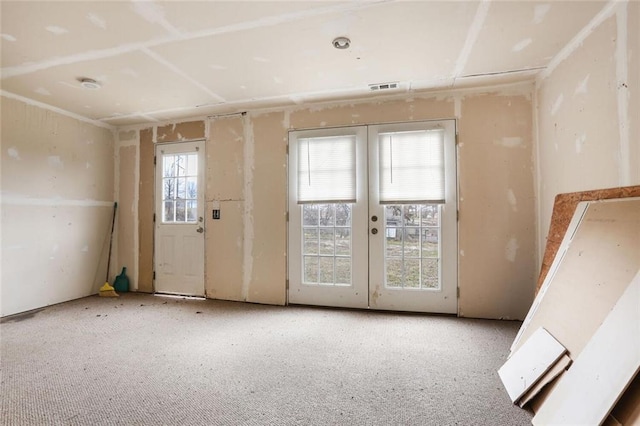 unfurnished room with visible vents and french doors