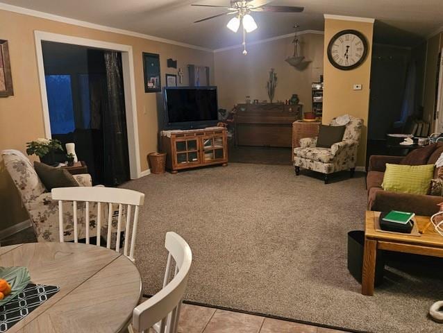 living room with light colored carpet, ceiling fan, baseboards, and ornamental molding