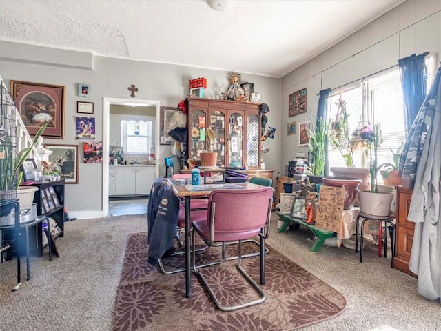 dining space with carpet floors and a textured ceiling