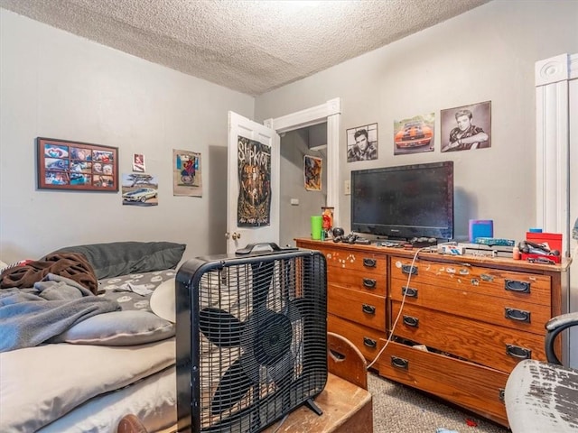 carpeted bedroom with a textured ceiling