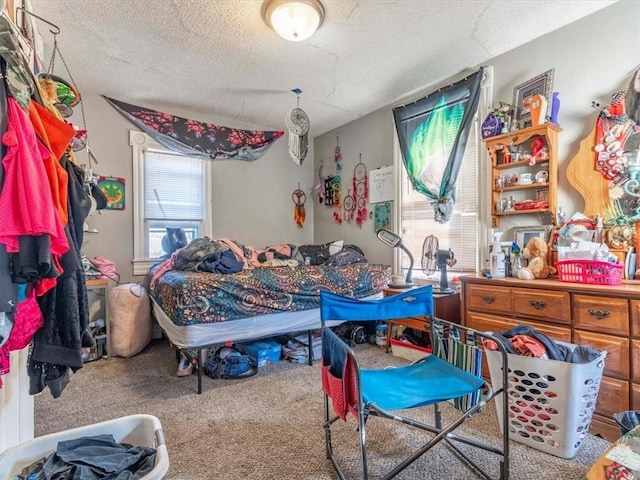 bedroom featuring carpet flooring and a textured ceiling