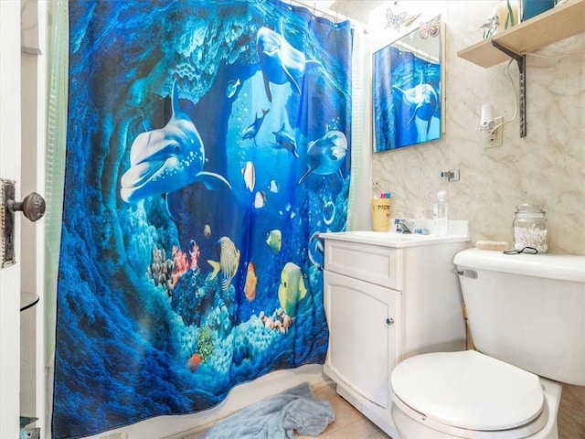 bathroom featuring a shower with shower curtain, toilet, vanity, and tile patterned flooring