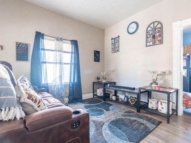 living room with wood finished floors and baseboards