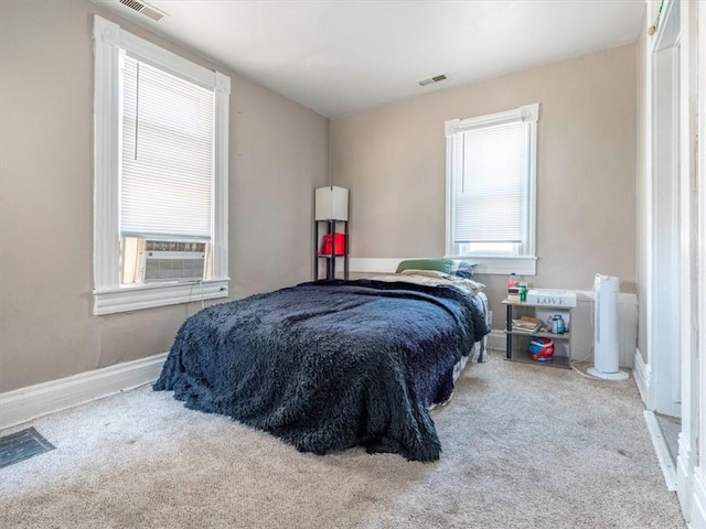 bedroom with visible vents, carpet floors, and baseboards