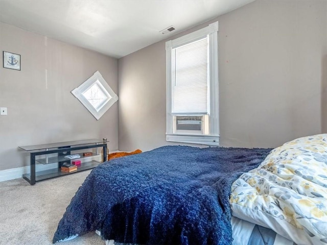 bedroom featuring visible vents, cooling unit, and carpet flooring