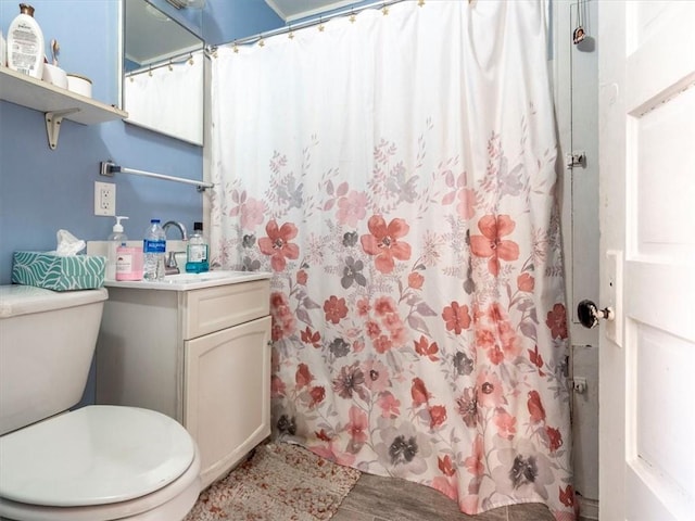 full bathroom featuring vanity, curtained shower, toilet, and wood finished floors