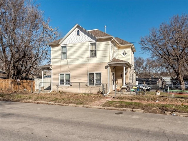 victorian home with a fenced front yard