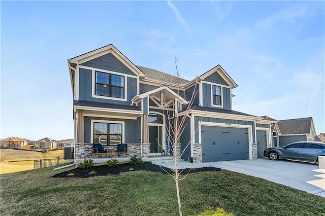 view of front facade with driveway, stone siding, board and batten siding, an attached garage, and a front yard