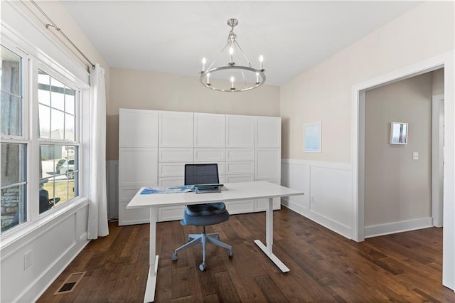 office area featuring plenty of natural light, dark wood-style floors, visible vents, and a chandelier