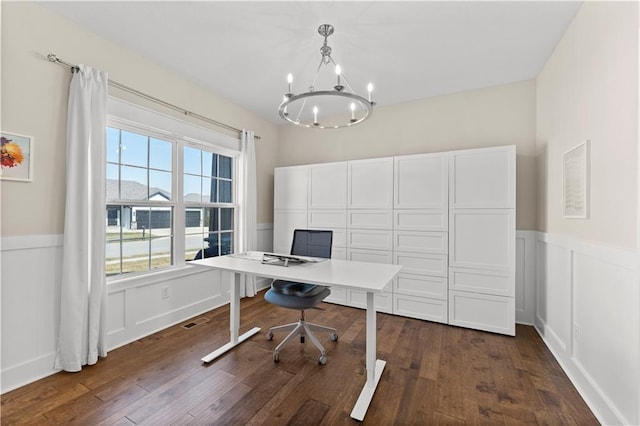 home office with a wainscoted wall, visible vents, an inviting chandelier, dark wood-type flooring, and a decorative wall